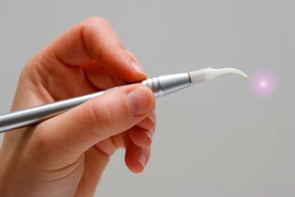Image of hand holding dental laser
